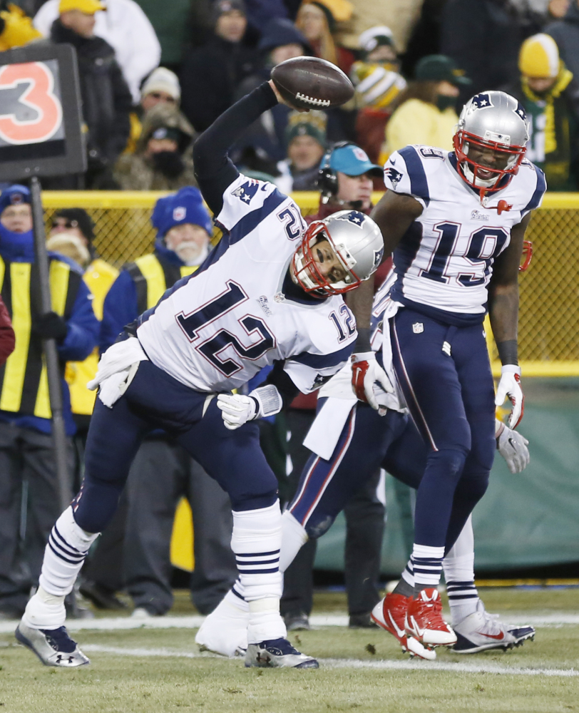 New England Patriots’ Tom Brady spikes the ball after throwing a touchdown pass to Brandon LaFell, 19, during the first half last week against the Green Bay Packers. The Patriots play the San Diego Chargers on Sunday night in San Diego.