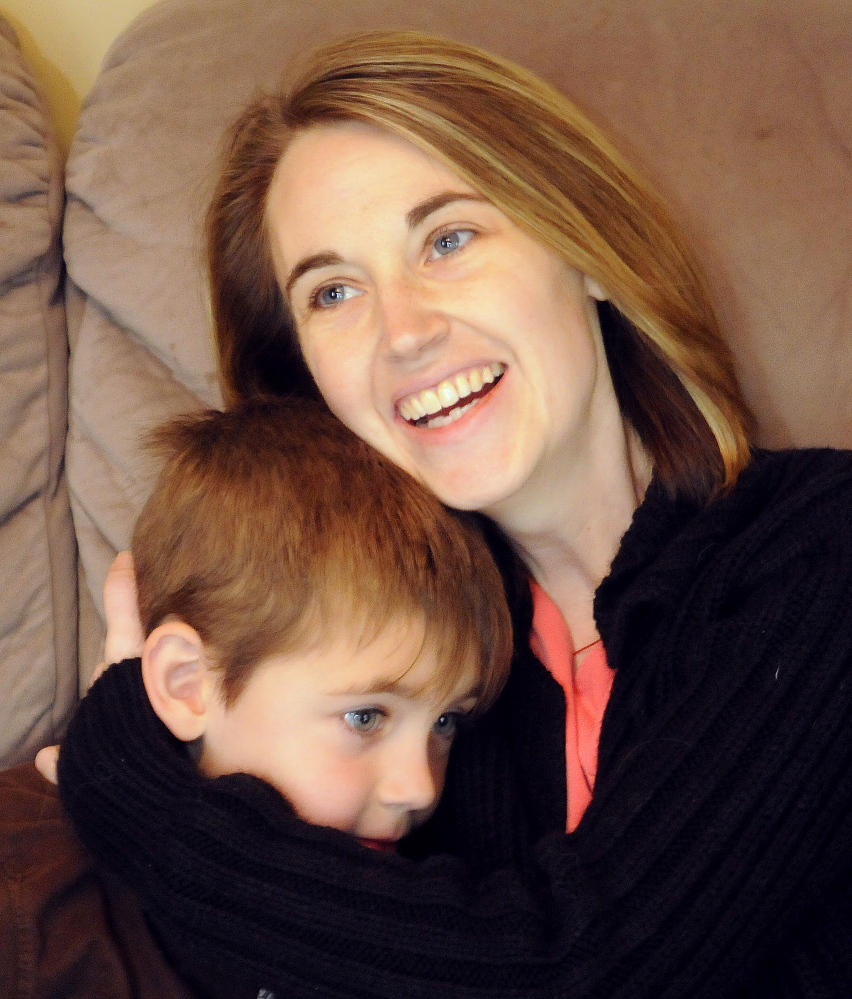 Cyndi MacMaster hugs her son Tripp, 5, on Sunday at their Dresden home. People are rallying behind MacMaster and her family after a devastating recurrence of cancer by donating funds so she can seek alternative treatments.