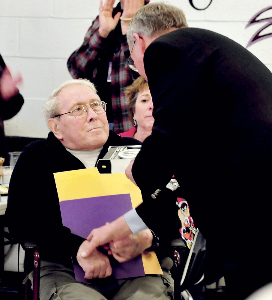 Retiring Waterville School Board member and chairman Lee Cabana shakes hands with Superintendent Eric Haley as he was honored for more than 50 years service to local schools on Monday