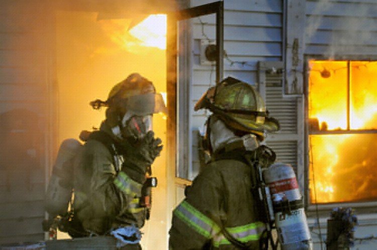 Firefighters battle a blaze at an apartment on State Street in Augusta Tuesday morning.