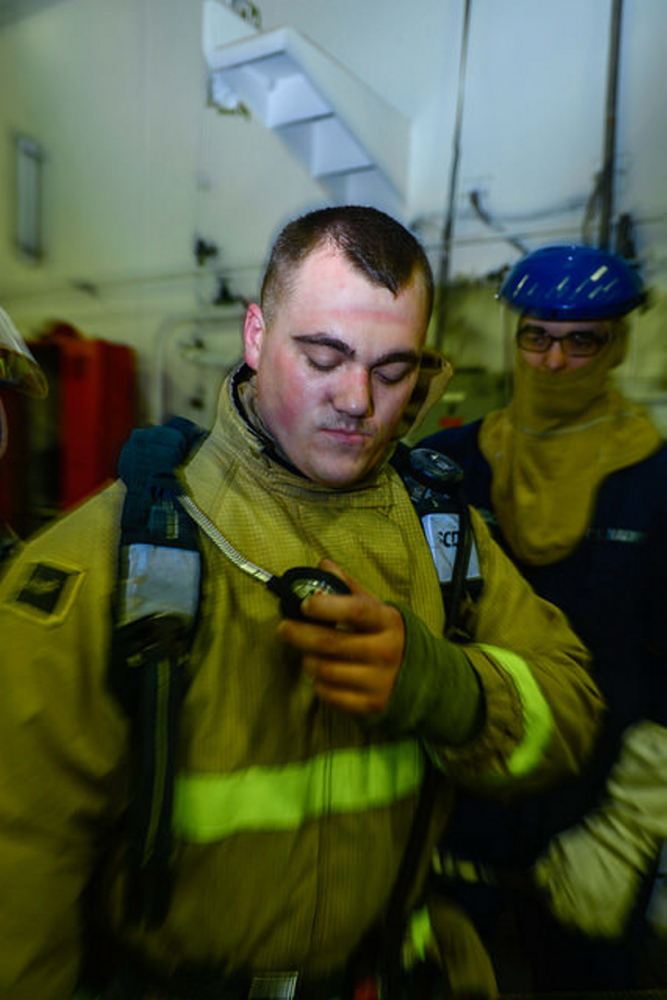 Contributed photo Damage Controlman Fireman Sean Cote, from Winslow, Maine, checks his air time indicator after a fire drill aboard Nimitz-class aircraft carrier USS John C. Stennis (CVN 74) in the Pacific Ocean. Stennis is currently undergoing an operational training period in preparation for future deployments, according to a news release from the U.S. Navy.
