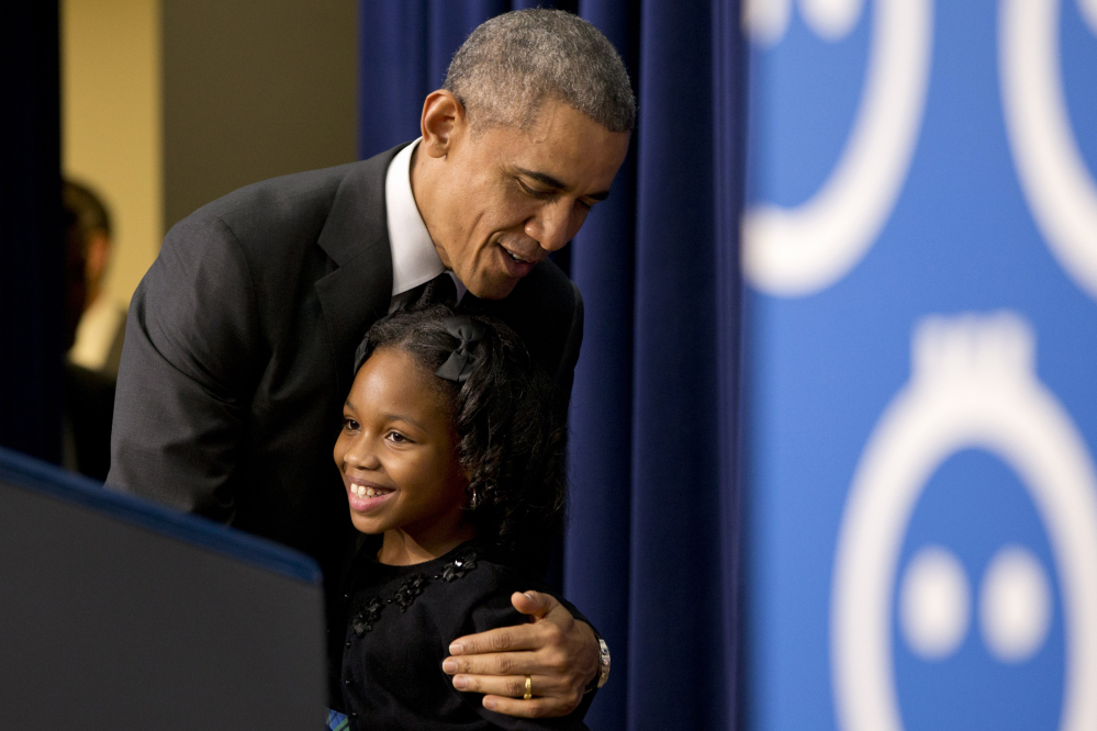 President Barack Obama hugs Alajah Lane, 9, of Washington, after she introduced him at the White House on Wednesday, when he spoke about early childhood education.