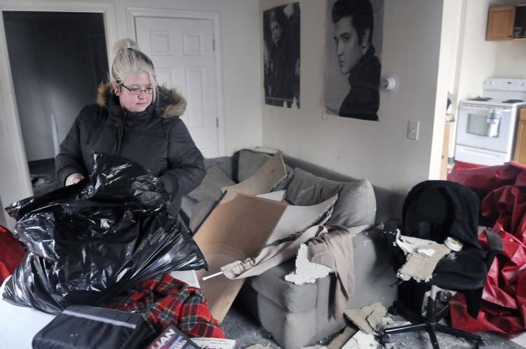 Sarah Holland packs up her belongings Wednesday after her apartment on State Street in Augusta was destroyed in a fire Tuesday. Holland said she’s looking for an apartment to enable her to work and go to school.