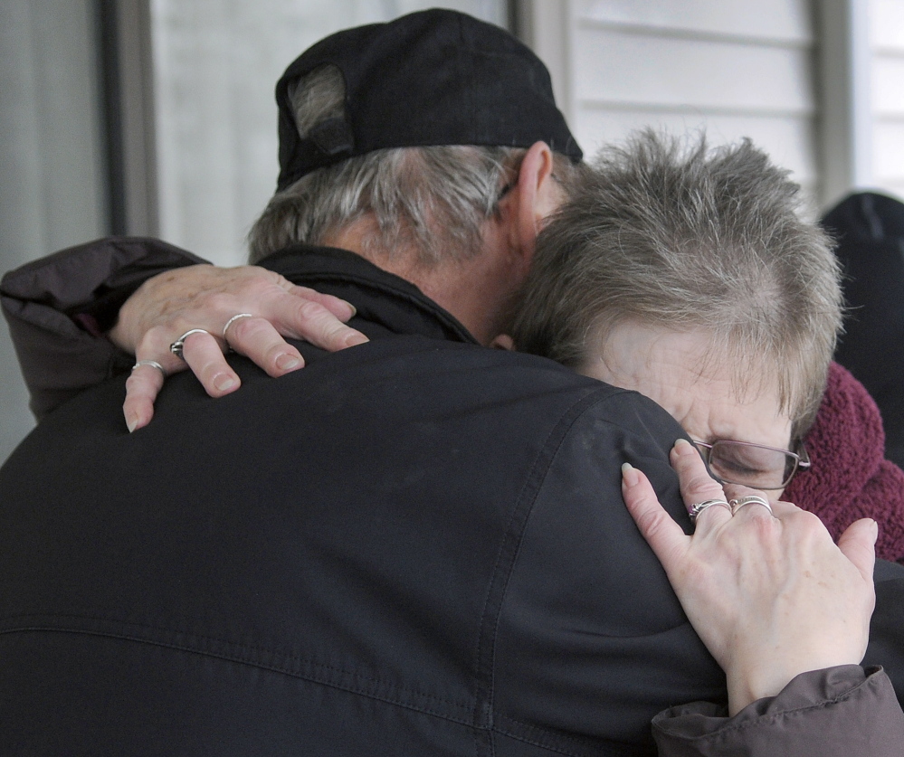 Alice Ingalls hugs Richard Reed on Wednesday after he gave her a donation at a motel in Augusta where she has been staying since losing her apartment to a fire last week. Ingalls said she shops at the Augusta Farmers Market, where Reed, of Readfield, maintains a booth.