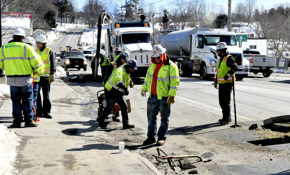Employees of Summit Natural Gas of Maine and sub-contractors work on the gas pipeline in the center of Norridgewock in March. Safety violations by contractors of the company have led to fines.