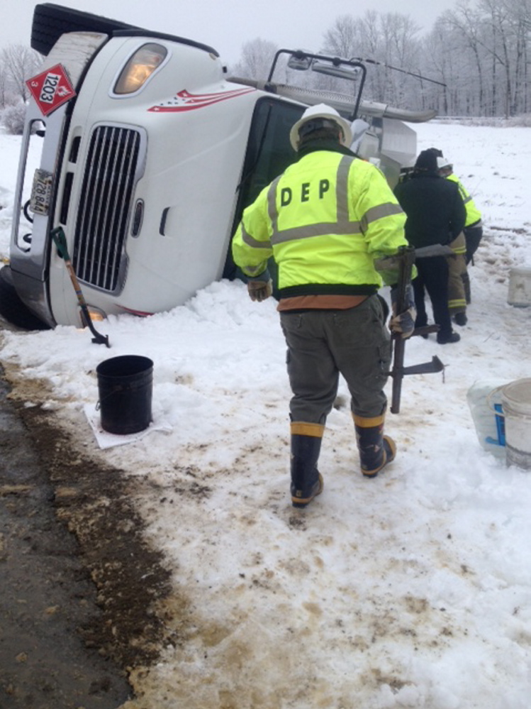 State Department of Environmental Protection crews responded to the scene of an oil spill on Bigelow Hill Road in Skowhegan on Friday morning after an oil delivery truck flipped over.