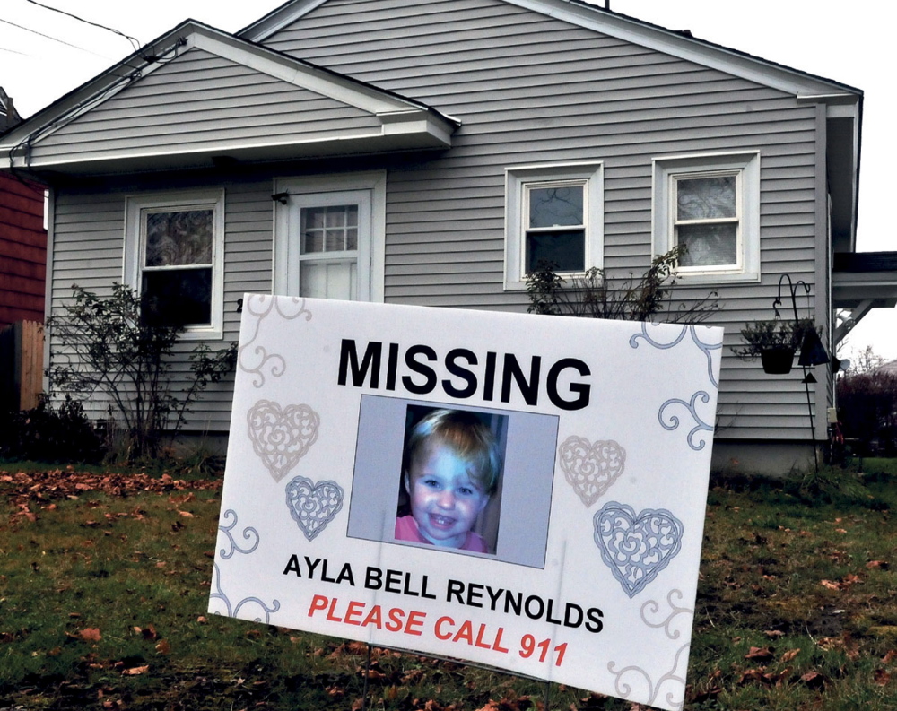 STILL MISSING: A sign and photograph of Ayla Reynolds has been placed in front of 29 Violette Ave. in Waterville where she was reported missing nearly a year ago.