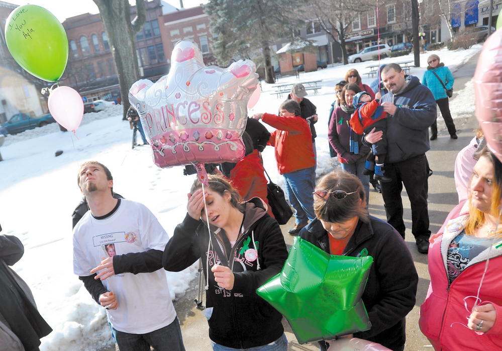 Justin DePietro, far left, Trista Reynolds, center left, parents of missing toddler Ayla Reynolds, release balloons during a vigil in Castonguay Square in Waterville in January 2012. Becca Hanson, right center, mother of Trista Reynolds, and Amanda Benner, far right, friend of Trista Reynolds, also are seen.