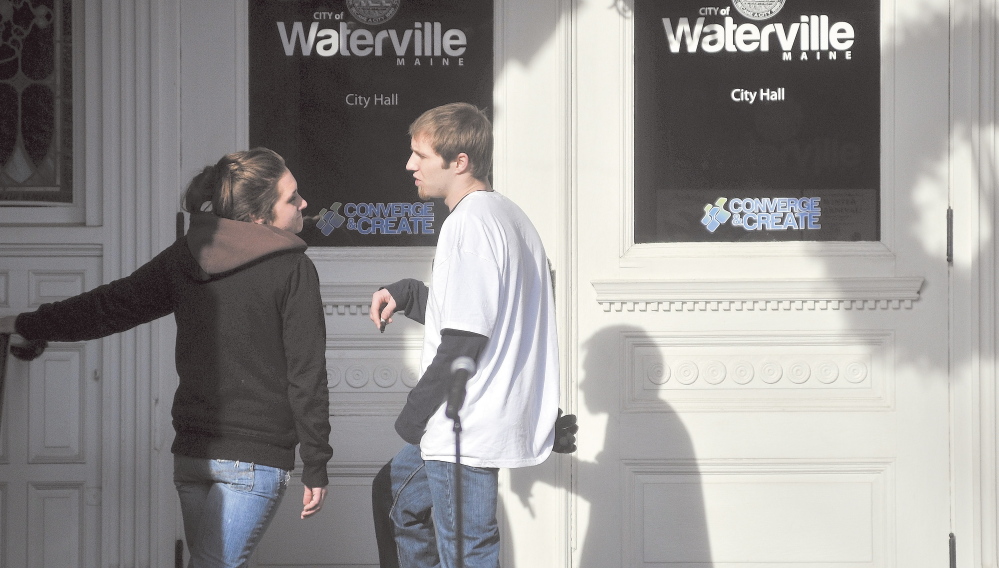 Trista Reynolds, left, and Justin DePietro, right, speak on the steps of City Hall during a vigil in Castonguay Square in Waterville in January 2012.