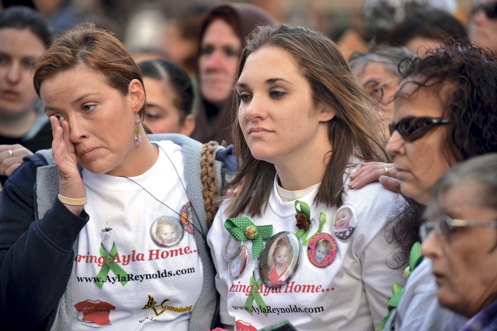 A rally in support of Ayla Reynolds is held in Portland’s Monument Square on her 2nd birthday, April 4, 2012. Ayla’s mother, Trista Reynolds (right) and her friends, including Ashley Pouliot (left) listen to a song written for Ayla by musician Alan Pouliot, from Fairfield.