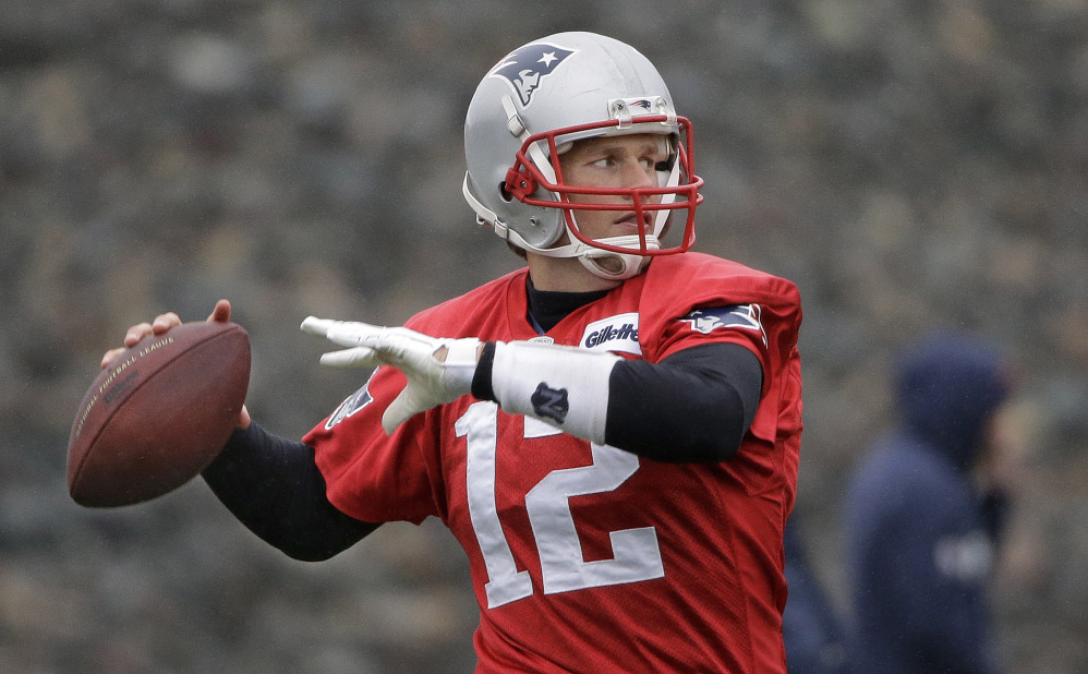 New England Patriots quarterback Tom Brady throws a pass during practice at the team’s facility in Foxborough, Mass. The Patriots will play the Miami Dolphins Sunday in Foxborough with a chance for the Patriots to clinch the AFC East and a playoff spot.
