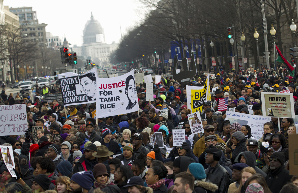 Demonstrators chant at Freedom Plaza in Washington, Saturday during the Justice for All rally. More than 10,000 protesters are converging on Washington in an effort to bring attention to the deaths of unarmed black men at the hands of police.
