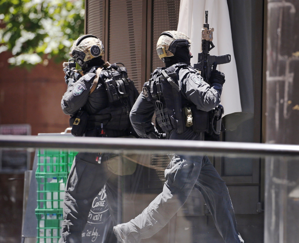 A police officer runs across Martin Place near the Lindt Chocolat Cafe, where hostages were being held by a gunman Monday morning in central Sydney.
It was not known how many hostages were in the cafe, or what motivated the incident.