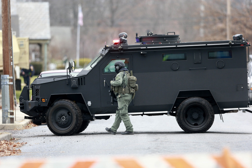Police move near the scene of a shooting Monday, , in Souderton, Pa. Police are surrounding a home in Souderton, outside Philadelphia, where a suspect is believed to have barricaded himself after shootings at multiple homes.