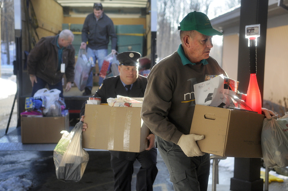 Togus employees, from right, Stan Coutts, Quinten Toothaker, Greg Veilleux and Harold Elliott unload gifts from the federal hospital’s employees at the Salvation Army in Augusta on Monday.