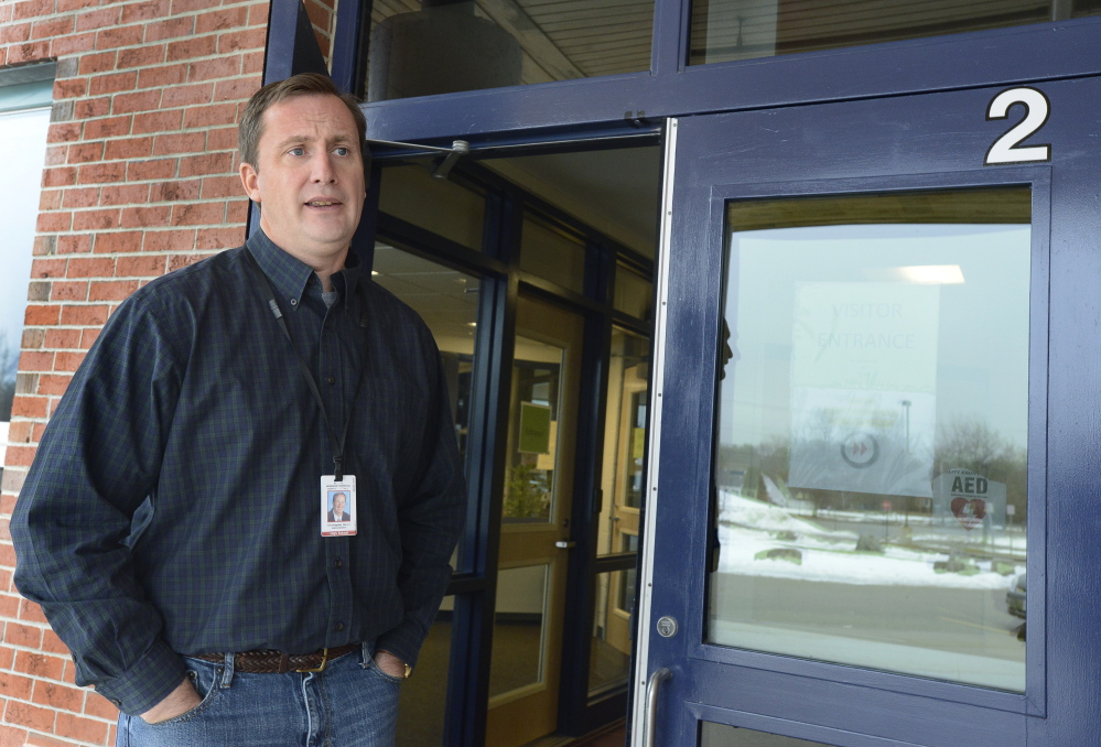 Windham high school principal Christopher Howell speaks briefly outside the locked high school doors as he, parents and students react to closure of schools due to a threat. John Patriquin/Staff Photographer