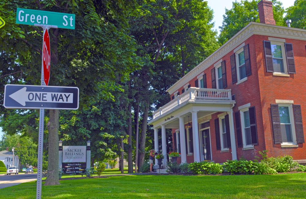 The traffic signs at the corner of Green and State streets in front the McKee Billings law offices, seen in a photo taken on July 25. City officials are debating whether to change the one-way portion of the street to two-way traffic.