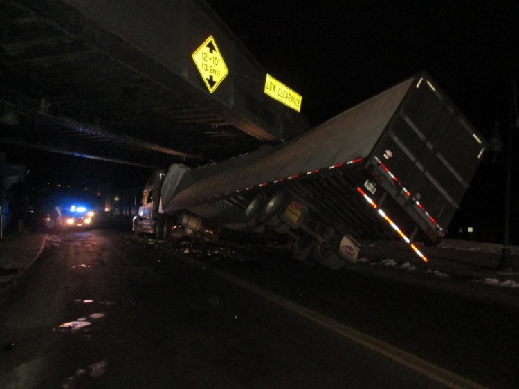 A tractor-trailer got stuck under the railroad bridge on Water Street in Augusta around 11:30 p.m. Monday. The driver wasn’t injured, but the trailer was damaged extensively, police said.