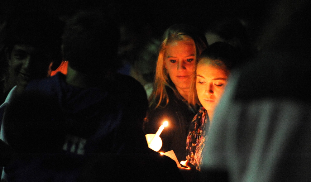 Friends and family of Cassidy Charette gather on Oct. 14 for a candlelight vigil at Mount Merici School in Waterville.