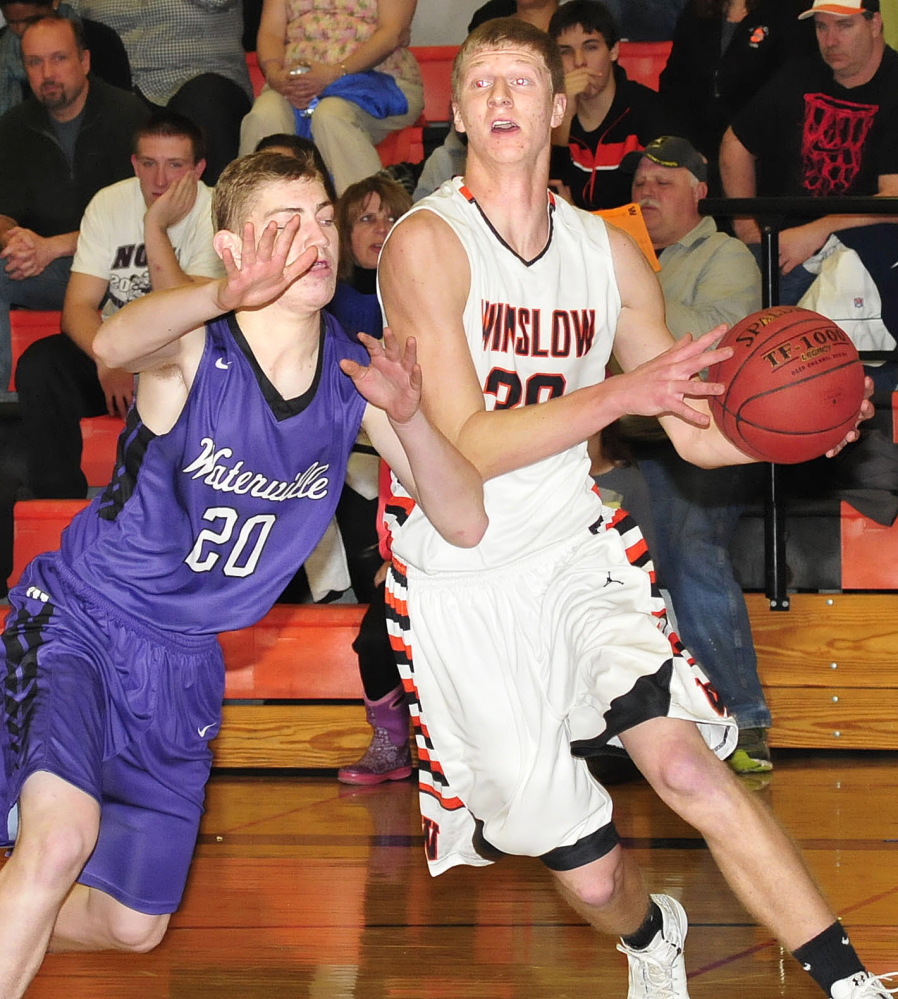 Winslow’s Justin Martin drives with the ball against Waterville’s Adam Barre at Winslow on Tuesday.