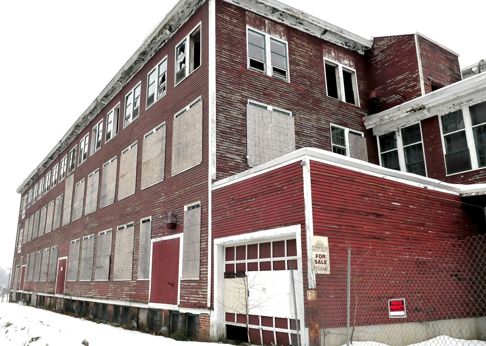 The closed and boarded-up Forster Mill building is part of a district proposed to be declared a slum and blight area, making the town eligible for federal assistance.