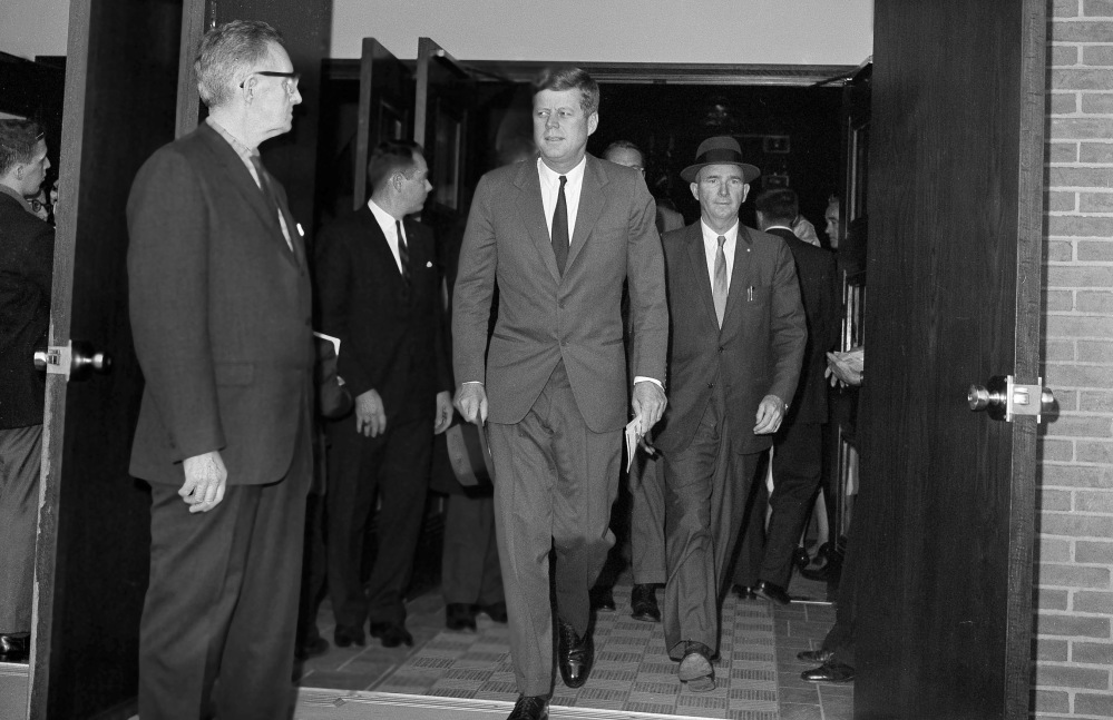 FILE - In this Oct. 28, 1962, President John F. Kennedy leaves St. Stephen's Roman Catholic Church after attending services in Washington D.C. shortly after the announcement from Moscow that Premier Khrushchev ordered Soviet rocket bases in Cuba dismantled and rockets returned to Russia. A U.S. blockade forced the removal of Soviet nuclear missiles from Cuba after a standoff brought the world near nuclear war. Kennedy agreed privately not to invade Cuba. On Wednesday, Dec. 17, 2014, the U.S. and Cuba agreed to re-establish diplomatic relations and open economic and travel ties, marking a historic shift in U.S. policy toward the communist island after a half-century of enmity dating back to the Cold War. (AP Photo/John Rous, File)