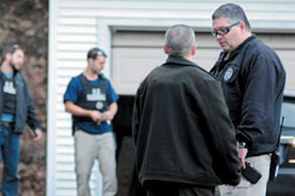 In this November 2012 file photo, U.S. Marshals Service investigators search the residence of Barbara Cameron, the ex-wife of James Cameron, in Hallowell. Authorities spent more than two weeks looking for Cameron in 2012 after he cut off his electronic monitoring bracelet and drove to New Mexico before being captured. Maine’s former top drug prosecutor fled the state after learning his appeal of child pornography convictions had failed.