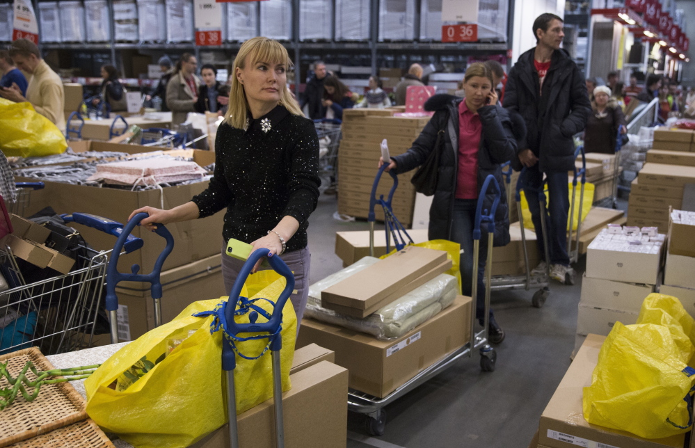 Consumers wait to pay Wednesday at the Ikea store on the outskirts of Moscow. The collapse of the national currency triggered a spending spree by Russians desperate to buy cars and home appliances before prices shoot higher.