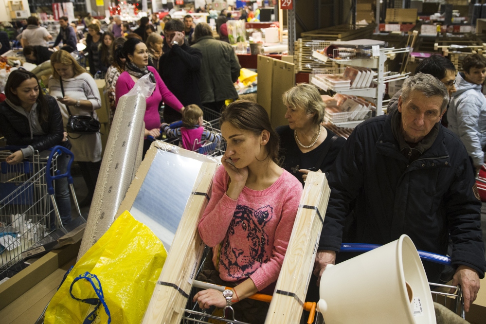 People wait in a line to pay for her purchases at the IKEA store on the outskirts of Moscow, Russia, Wednesday.