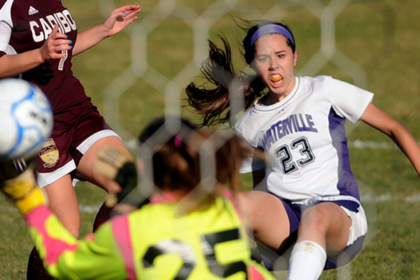 Waterville striker Pilar Elias, 23, scores against Caribou High School during an Eastern B semifinal game this fall. The Maine Soccer Coaches named Elias an All-American. 