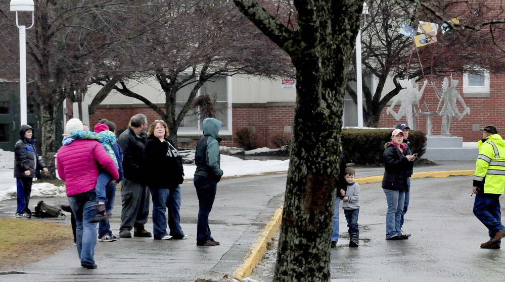 Parents of Benton Elementary School students wait for police to let them pick up their children after Wednesday’s lockdown of the school.