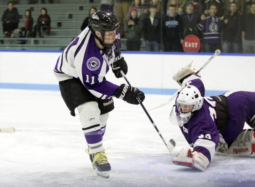 Waterville Senior High School forward Jackson Aldrich scores on Hampden Academy goalie Cole Benner during an Eastern B game Thursday at Colby.