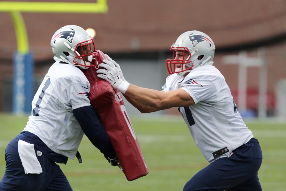 New England Patriots tight end Rob Gronkowski, right, pushes teammate Tim Wright during practice Wednesday in Foxborough, Mass. The Patriots play the New York Jets on Sunday in East Rutherford, N.J.