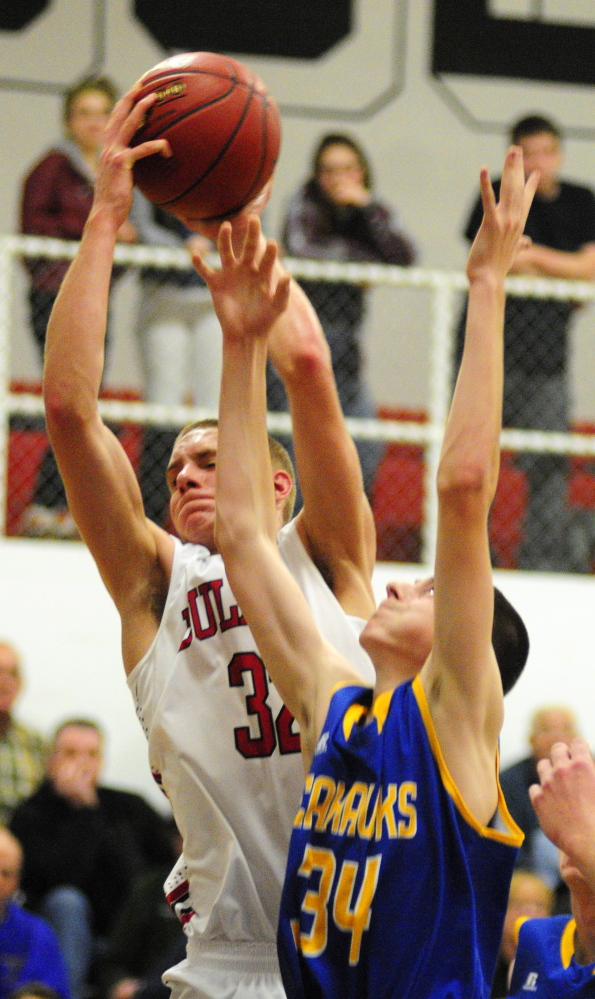 Hall-Dale’s Wesley LaPointe grabs a rebound in front of Boothbay’s Nick Burge during a Western C game Friday at Hall-Dale High School in Farmingdale.