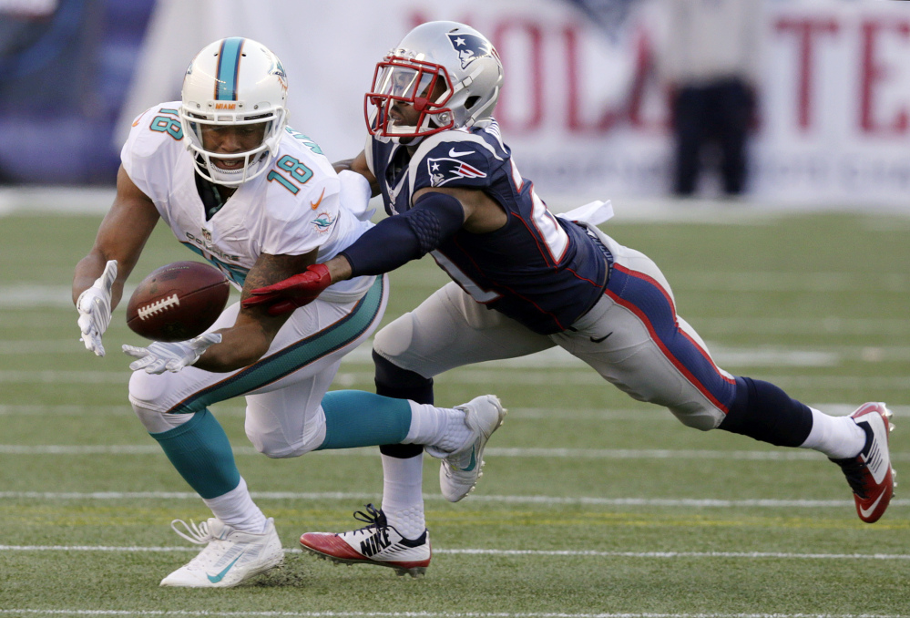 Miami Dolphins wide receiver Rishard Matthews (18) catches a pass as New England Patriots defensive back Malcolm Butler (21) defends in the first half last week in Foxborough, Mass. The Patriots play the New York Jets on Sunday in East Rutherford, N.J.