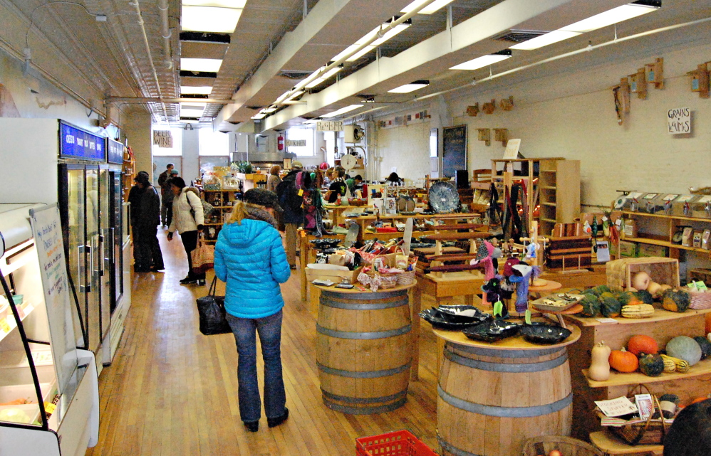 Shoppers peruse the wares of Barrels Community Market on Saturday in Waterville. Founded as a nonprofit by Waterville Main Street, the market sells Maine crafts and food.