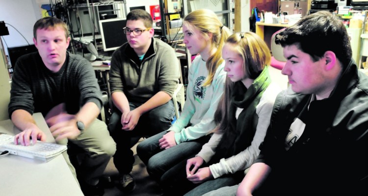Nokomis Regional High School teacher Kern Kelley, left, logs on to a Google Hangout chat site Dec. 15 for students from left Zack Mitchell, Austin Taylor, Britney Bubar and Jake McEwen at the school in Newport.