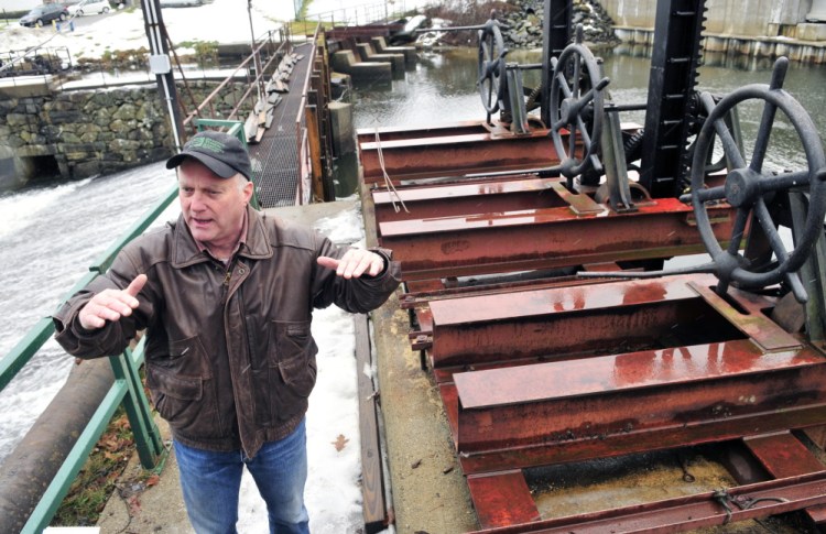 Jack Daniel, chairman of the New Mills Dam committee, leads a tour at the New Mills Dam on Thursday in Gardiner. The committee recently had new deep-water gates and posts replaced.