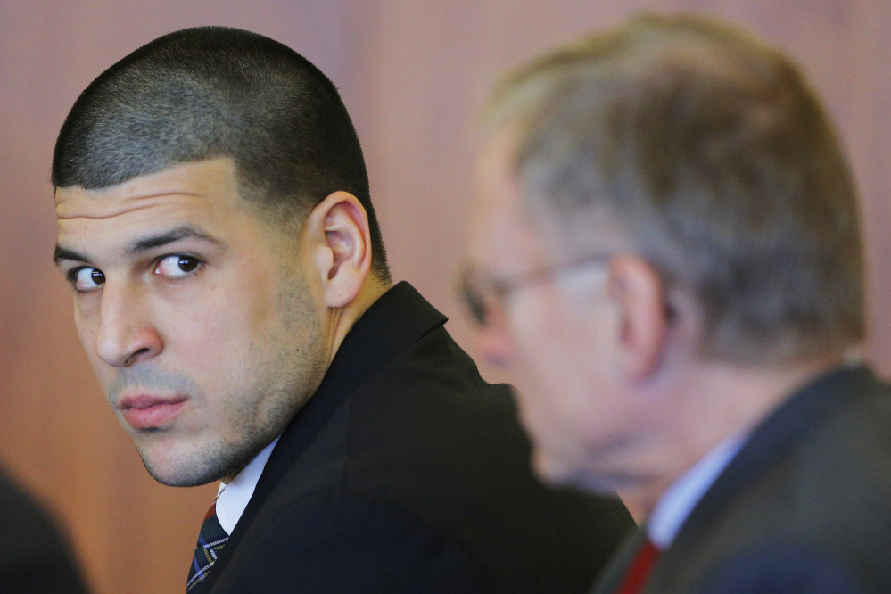 Former New England Patriots tight end Aaron Hernandez, left, attends a pretrial hearing in Fall River, Mass., Monday.