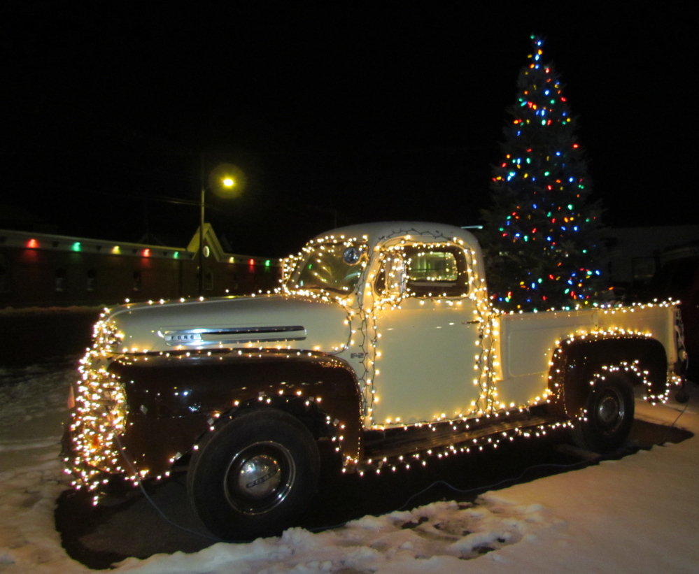 Photo by Tina Richard of Clinton 
 A Ford pickup truck is lit up with white Christmas lights with a tree in the bed of the truck in Skowhegan.