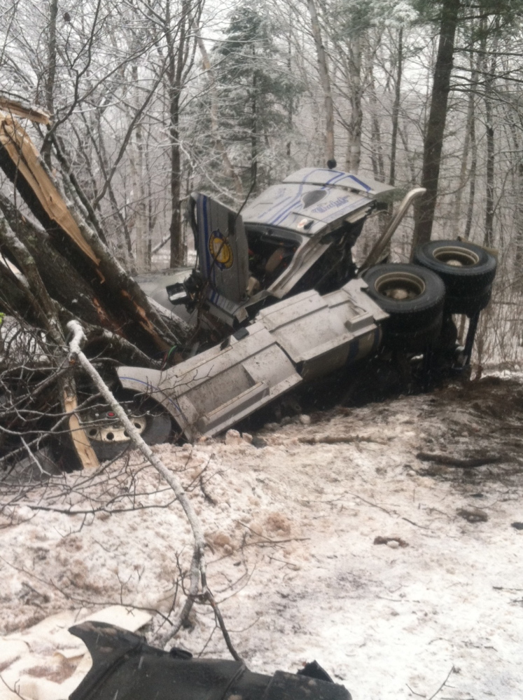 A tractor-trailer carrying crushed limestone rolled over on New Portland Road in Embden Tuesday morning and crews were on scene to contain any potential spills of limestone.