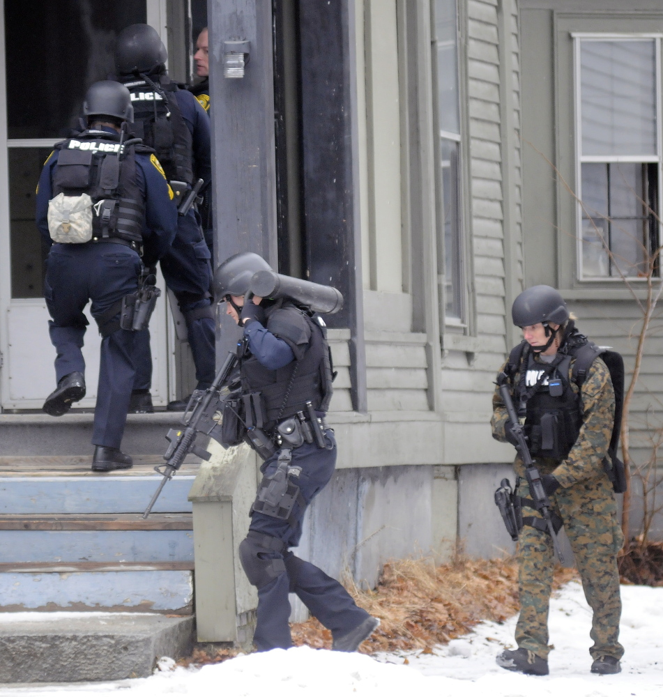 Augusta Police tactical team members make entry Tuesday into 388 Water St. to apprehend Lorne Sherwood.