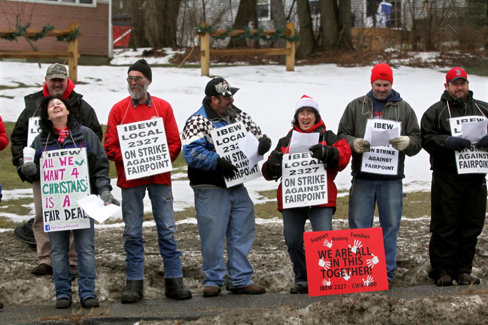 Striking FairPoint workers sing Christmas carols outside the Winslow home of Mike Reed, state president for FairPoint in Maine, on Tuesday.