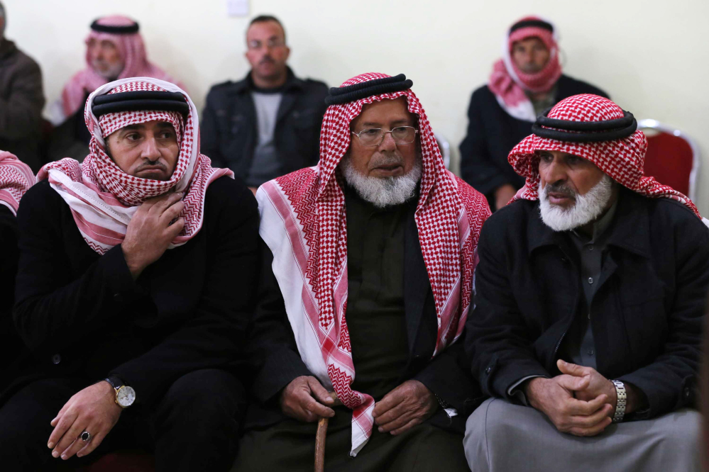 Friends and relatives of Mu’ath Safi al-Kaseasbeh, a Jordanian pilot captured by the Islamic State group, gather in the town of Aey near Al Karak in southern Jordan, on Wednesday.