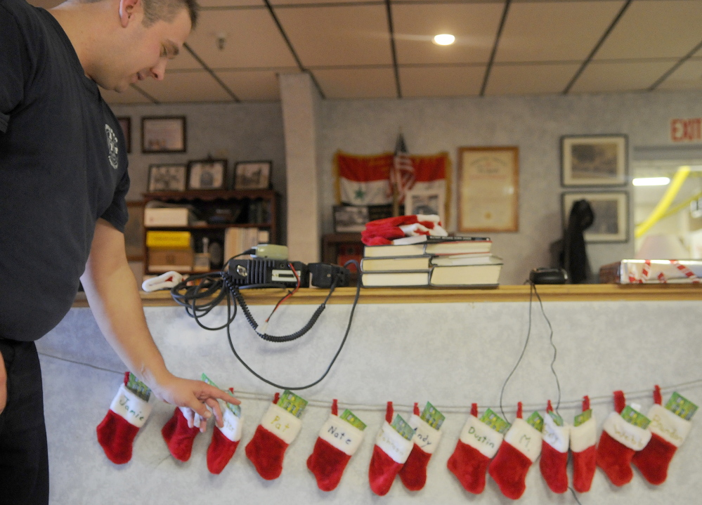 Gardiner Fire Dept. Captain Pat Saucier checks his stocking Thursday at the city’s station. Firefighters working Christmas shared dinner together and exchanged lottery tickets, Saucier said.