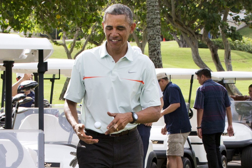 Surrounded by Secret Service Agents, President Barack Obama  tosses a golf ball between his hands after finishing the 18th hole of a game of golf with Malaysian Prime Minister Najib Razak on Wednesday at Marine Corps Base Hawaii’s Kaneohe Klipper Golf Course in Kaneohe, Hawaii, during the Obama family vacation.