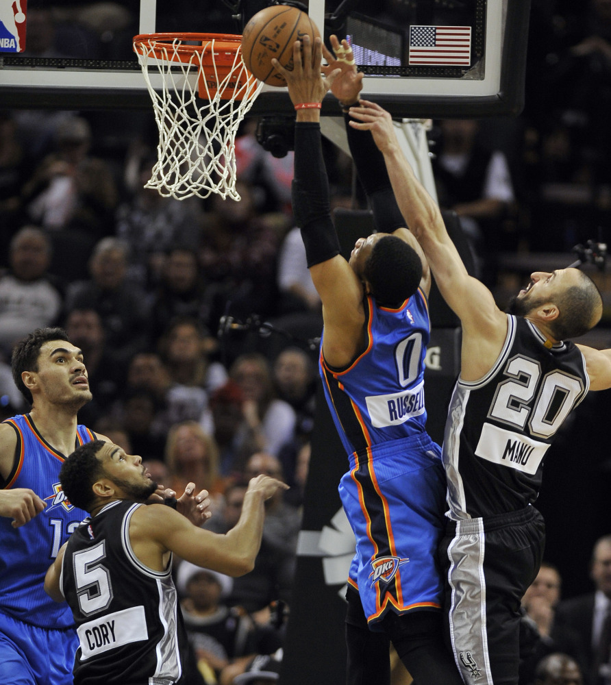 Oklahoma City Thunder guard Russell Westbrook (0) shoots against San Antonio Spurs guard Manu Ginobili (20) as Spurs’ Cory Joseph and Thunder’s Steven Adams, left, look on, in the first half Thursday in San Antonio. Oklahoma City won 114-106.