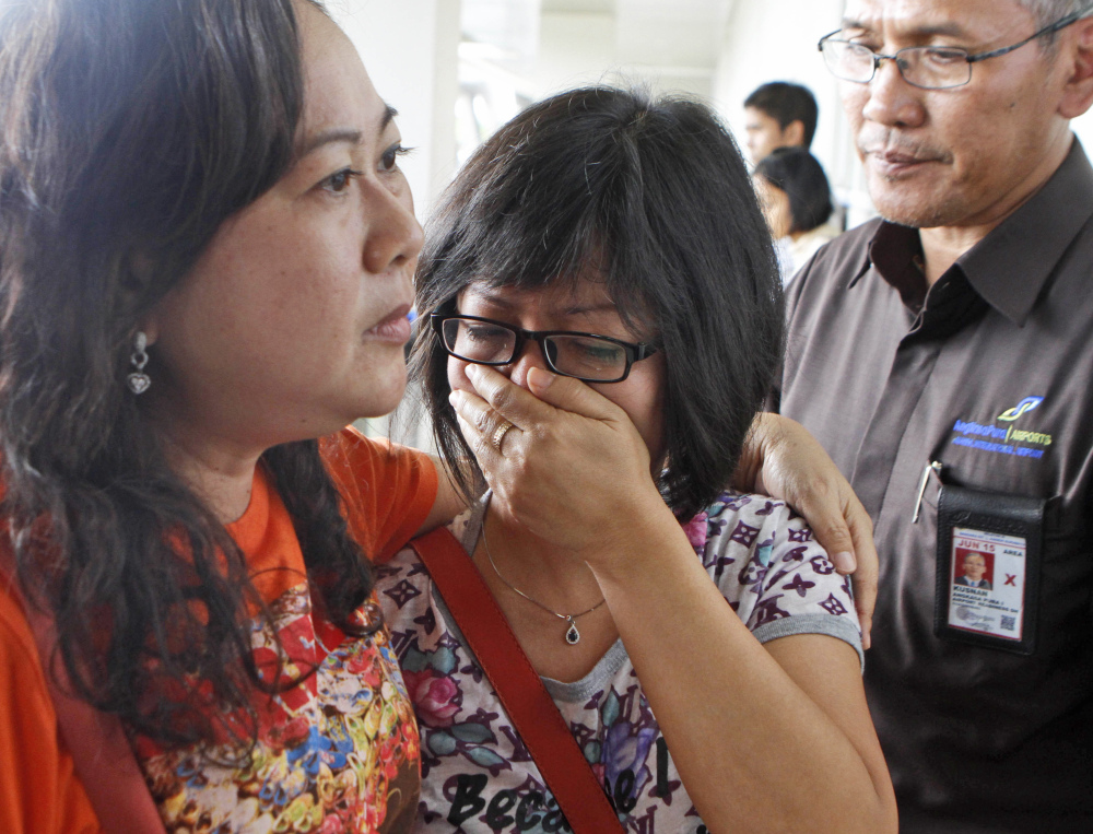 A relative of AirAsia flight QZ8501 passengers weeps as she waits for the latest news on the missing jetliner at Juanda International Airport in Surabaya, East Java, Indonesia, on Sunday.