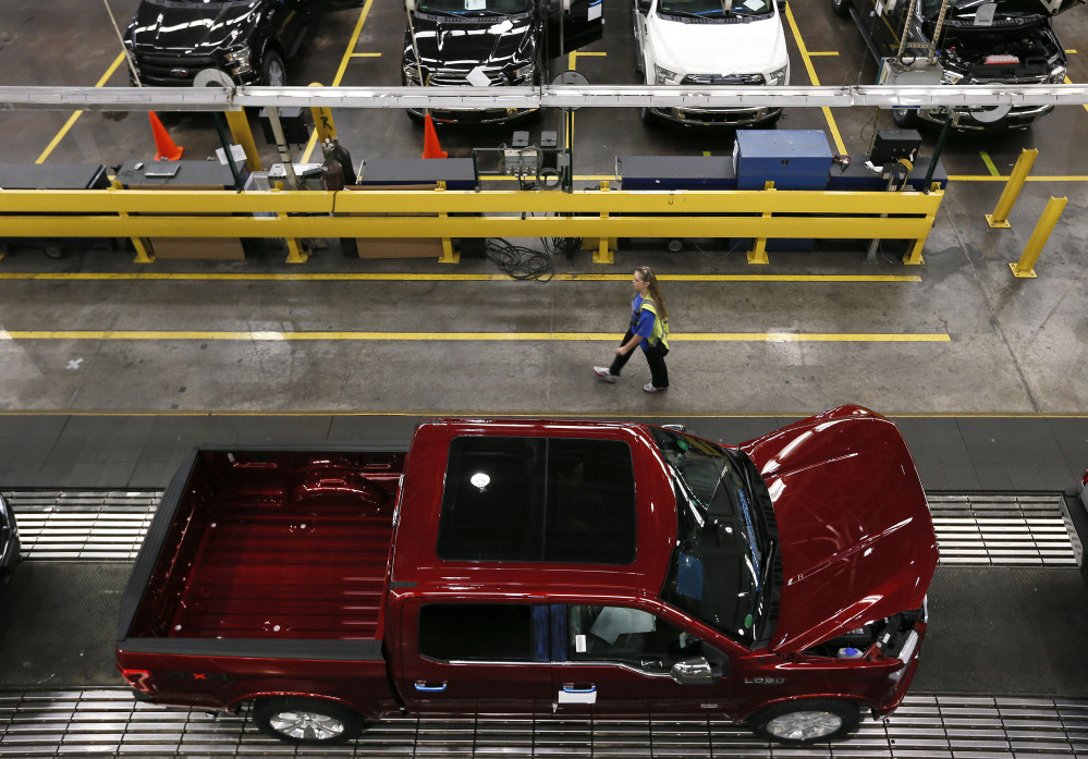 In this Nov. 11, 2014, file photo, 2015 Ford F-150 trucks are produced at the Dearborn Truck Plant in Dearborn, Mich. Six years after its financial system nearly sank and nearly that long since the recession ended, the United States seems poised to grow in 2015 at its fastest pace in a decade.