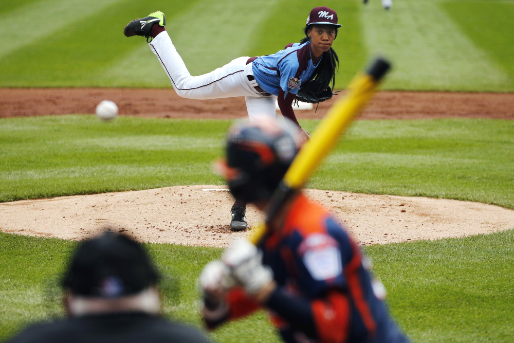 In this Aug. 15, 2014, file photo, Philadelphia’s Mo’ne Davis delivers in the first inning against Nashville’s Robert Hassell III during a baseball game in U.S. pool play at the Little League World Series tournament in South Williamsport, Pa.
